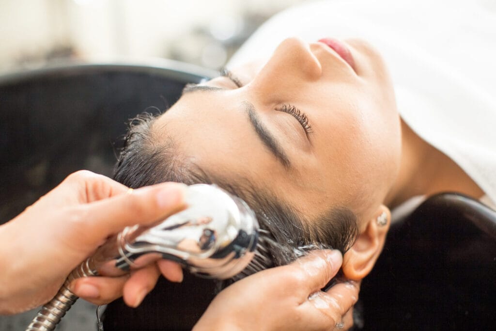 Close-up of young relaxed woman at hair salon